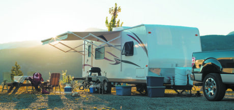 White recreational vehicle parked up at sunset