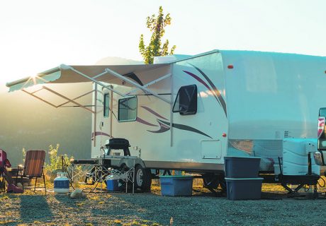 White recreational vehicle parked up at sunset